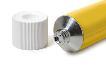 Sealed yellow tube of ointment and cap on a white background. Full depth of field. With clipping path