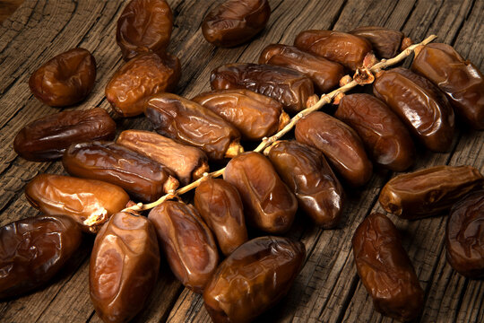 Dates tropical fruit branch on old wooden background