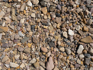 River pebbles close up. Natural pebble beach. Background for wallpaper, texture.