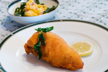 Viennese Fried Chicken Breast with Lemon Wheel and Fried Parsley