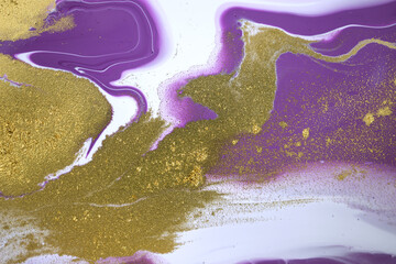 Marble purple acrylic texture with gold glitter. Close up liquid ink background.