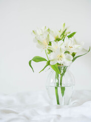 Alstroemeria flowers in vase on table on light background