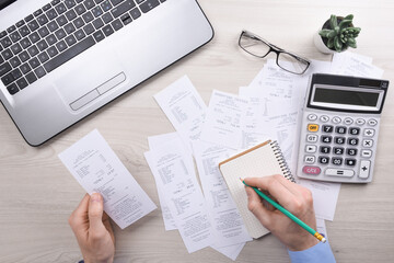 Unrecognizable businessman using calculator on desk office and writing make note with calculate...