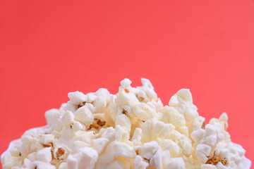 Popcorn in bowl on a red background. Close up. Top view