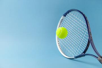 Tennis paddle rackets with ball on blue background. Summer sport activity concept. Flying