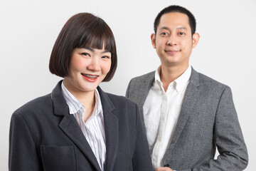 Fototapeta na wymiar Asians executive businessman and businesswoman smile and standing on white background.
