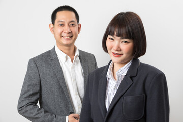 Asians executive businessman and businesswoman smile and standing on white background.
