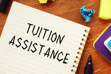 Financial concept meaning TUITION ASSISTANCE question marks with inscription on the piece of paper.