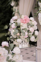 Wedding ceremony. Very beautiful and stylish wedding arch, decorated with various artificial flowers and mirror accesories.