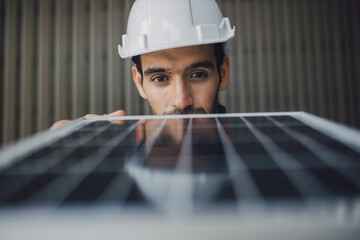 man touching and checking photovoltaic panel while working on solar power station on sunny day. Solar energy concept