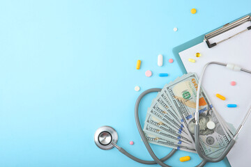 Medical stethoscope and money on a colored background top view close-up
