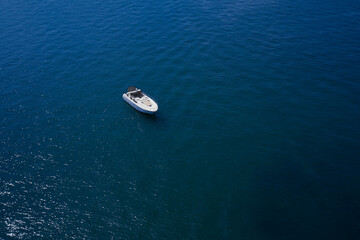 Aerial view luxury motor boat. Yacht on blue water. Top view of the boat.