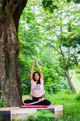 Indian girl practicing yoga, Outside in nature