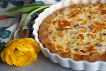 Kish. Homemade pie with salmon, scrambled eggs, vegetables and cheese.