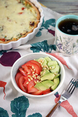 Vegetable salad with tomatoes, cucumbers, avocado and pine nuts