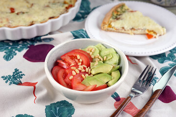 Vegetable salad with tomatoes, cucumbers, avocado and pine nuts