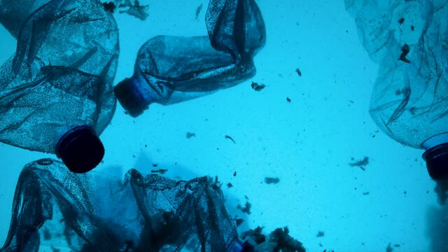 Underwater footage of plastic pollution problem concept in ocean.