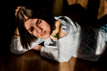 Beauty portrait of a beautiful young girl with a shadow pattern on the face and body in the form of...