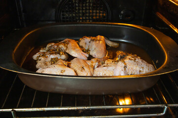 Chicken wings with garlic sauce are cooked in the oven. Cooking in the oven. Poultry dishes.