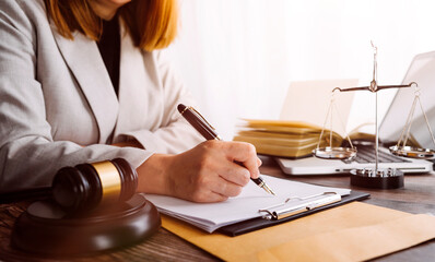 Business and lawyers discussing contract papers with brass scale on desk in office. Law, legal services, advice, justice and law concept