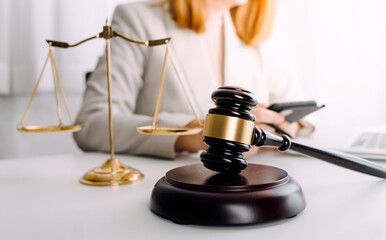 Business and lawyers discussing contract papers with brass scale on desk in office. Law, legal services, advice, justice and law concept