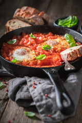 Shakshuka with eggs and tomatoes on Pan. Tunisian cuisine.