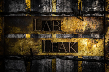 Lab Leak text on vintage textured grunge copper and gold steampunk background lined with barbed wire