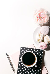 Obraz na płótnie Canvas cup of coffee, notebooks, pen, macaroons and peony flowers on white background 