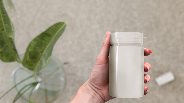 Hand Holding A Pill Bottle Template