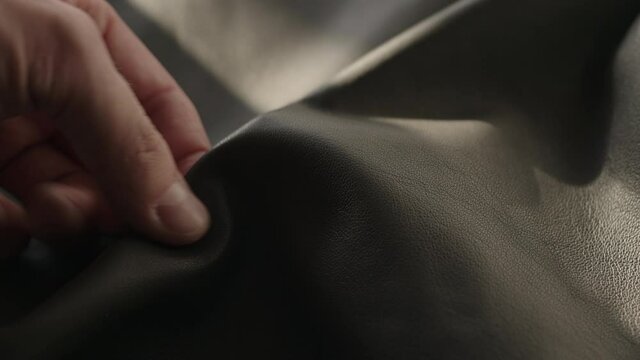 Man hand touching soft leather with sun shining from a window