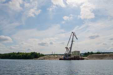 Fototapeta na wymiar Hoisting and river crane on the Dnieper river near Kyiv, Ukraine