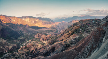 Mountain valley with red mountains. Morning panoramic view of a mountain valley with a serpentine road. Matlas Gorge.