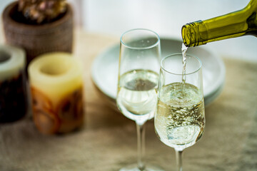 Two glasses of sparkling wine on dining table.Modern lifestyle image.

