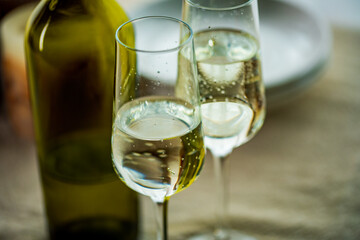 Two glasses of sparkling wine on dining table.Modern lifestyle image.
