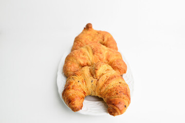 Fresh and tasty croissant in white plate white background.