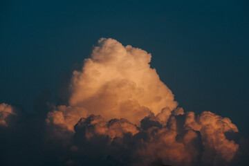 Close up shot of orange colored fluffy sunset clouds in sky