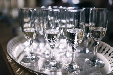 Lots of champagne glasses in a luxurious atmosphere. Stylish, Socialite reception, new year, wedding