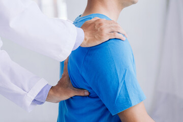 Male doctor therapist working examining treating injured back.Back pain patient, treatment, medical doctor,massage for back pain relief office syndrome.