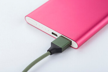 Power bank for charging mobile devices. Pink smart phone charger with power bank. battery bank.