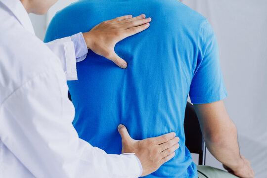 Male Doctor Therapist Doing Healing Treatment On Man's Back.Back Pain Patient, Treatment, Medical Doctor,massage For Back Pain Relief Office Syndrome