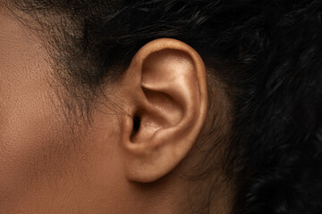Closeup view of black female ear - obrazy, fototapety, plakaty