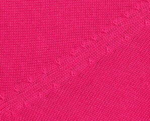 Close up of knitted pullover texture in hot pink