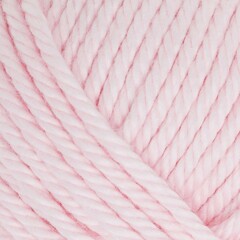 Close up of knitting yarn texture in pale pink