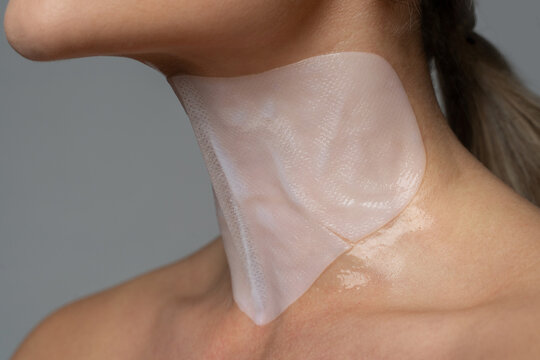 Woman With A Sheet Mask Applied On Her Neck