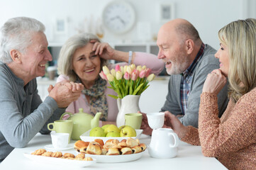 two  Senior couples drinking tea