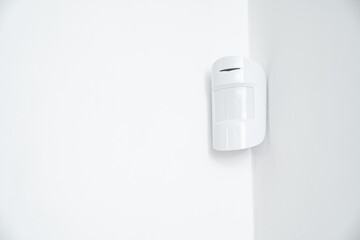 motion sensor in the white corner. device that tracks movement of objects.