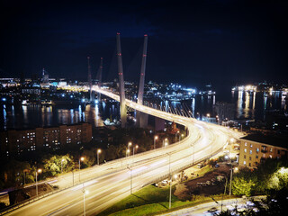 Fototapeta na wymiar Golden Bridge over the Golden Horn Bay in Vladivostok on an autumn night in the light of night lights