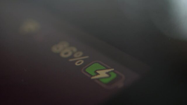 Close up macro shot of the battery level indicator on a smart phone being charged