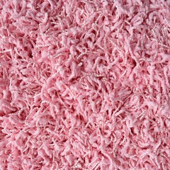 Pink shaggy carpet texture, close up