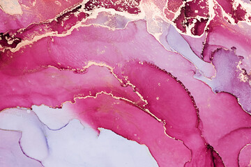 Abstract liquid ink painting background in pink colors with gold splashes